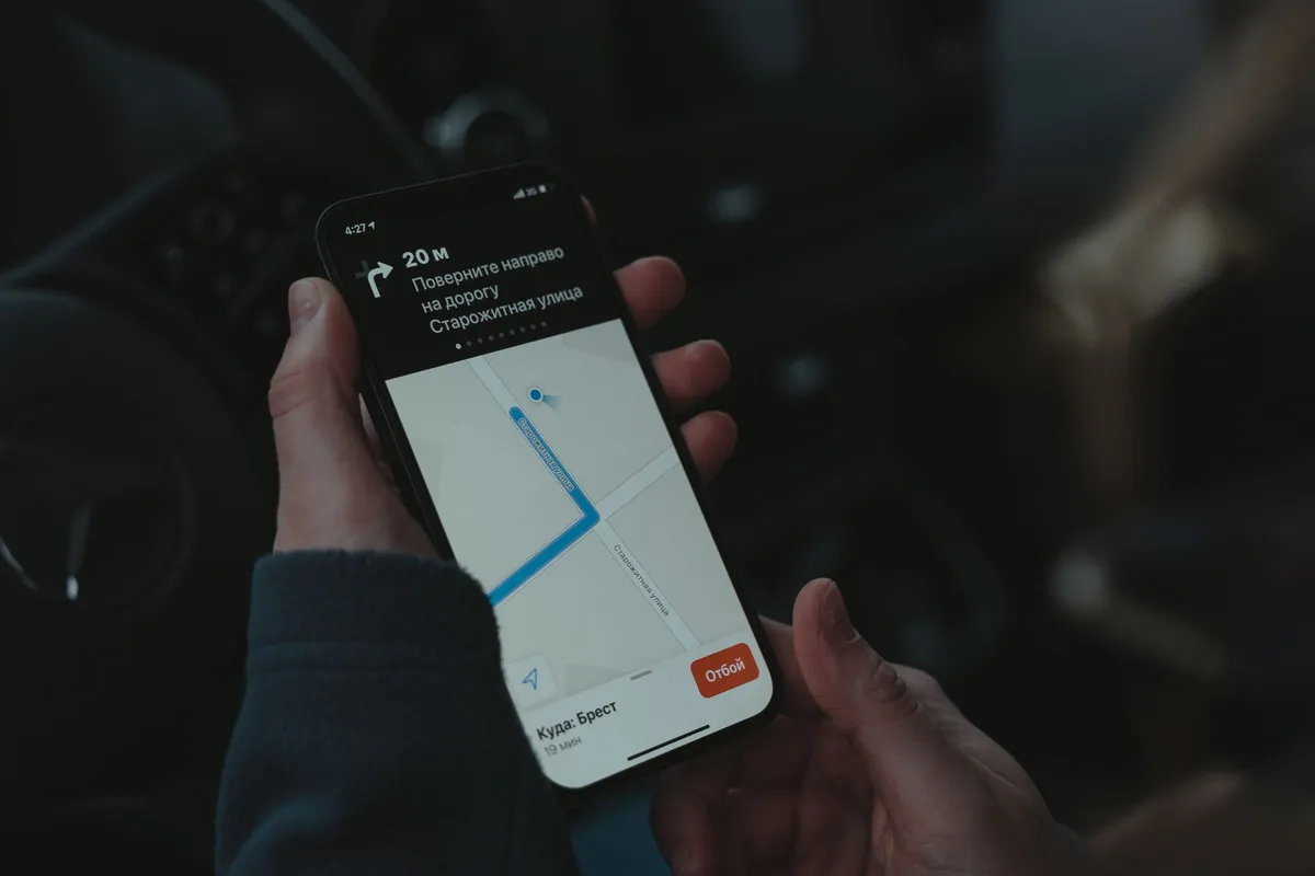 Hand holding an Android smartphone showing a map with route directions